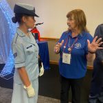 Volunteers speaking with veterans at the Women in the Air Force Association luncheon.