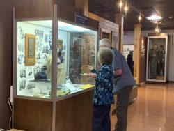 Airman Heritage Foundation Secretary, Joan Lopez, showcases a display in which her father is highlighted.