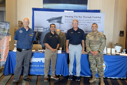 Two members of the AHF and a member of the Airman Heritage Museum staff take a photo with Chief Master Sergeant of the Air Force #15 Rodney J. McKinley.